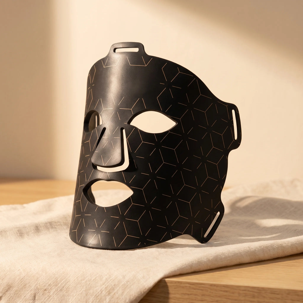 Clinirae Light Mask, flexible black LED face mask, on cream linen