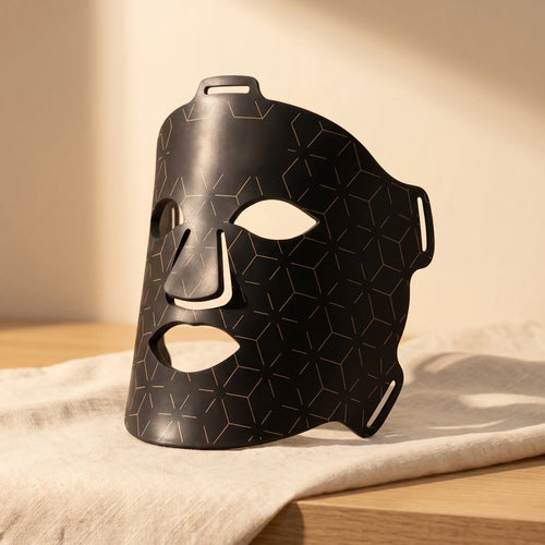 Clinirae Light Mask, flexible black LED face mask, on cream linen